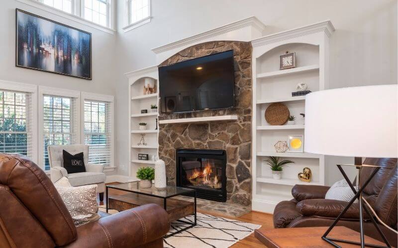 stone fireplace with TV above