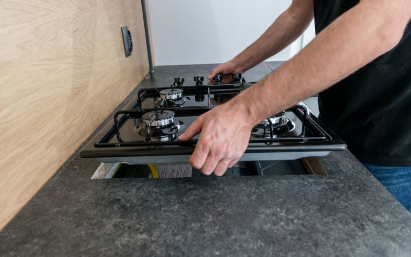 man installing a gas stove